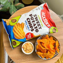 Load image into Gallery viewer, Jackson&#39;s Wavy Sea Salt Sweet Potato Chips kettle cooked in avocado oil on a table with dip
